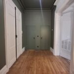 Entrance hall with wooden floors in traditional Bordeaux apartment
